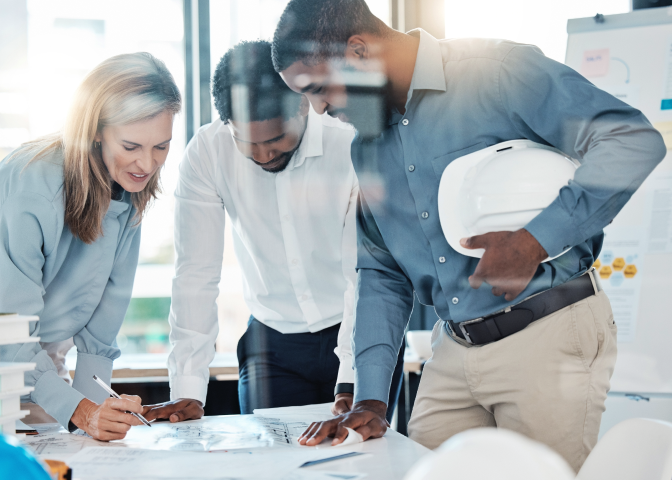 Group of coworkers looking at design plans