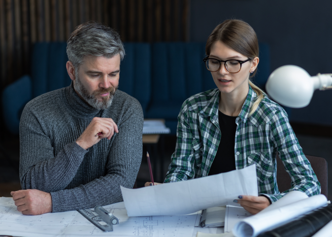 Two colleagues looking at designs
