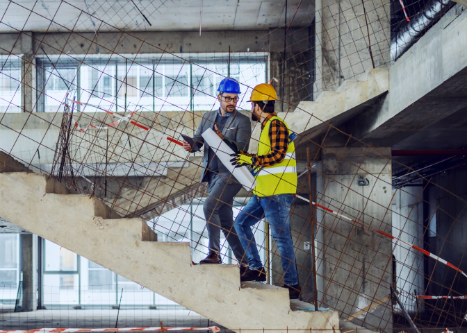 Two engineers going up stairs on site