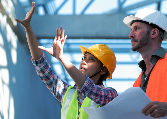 Two engineers on site showing hands